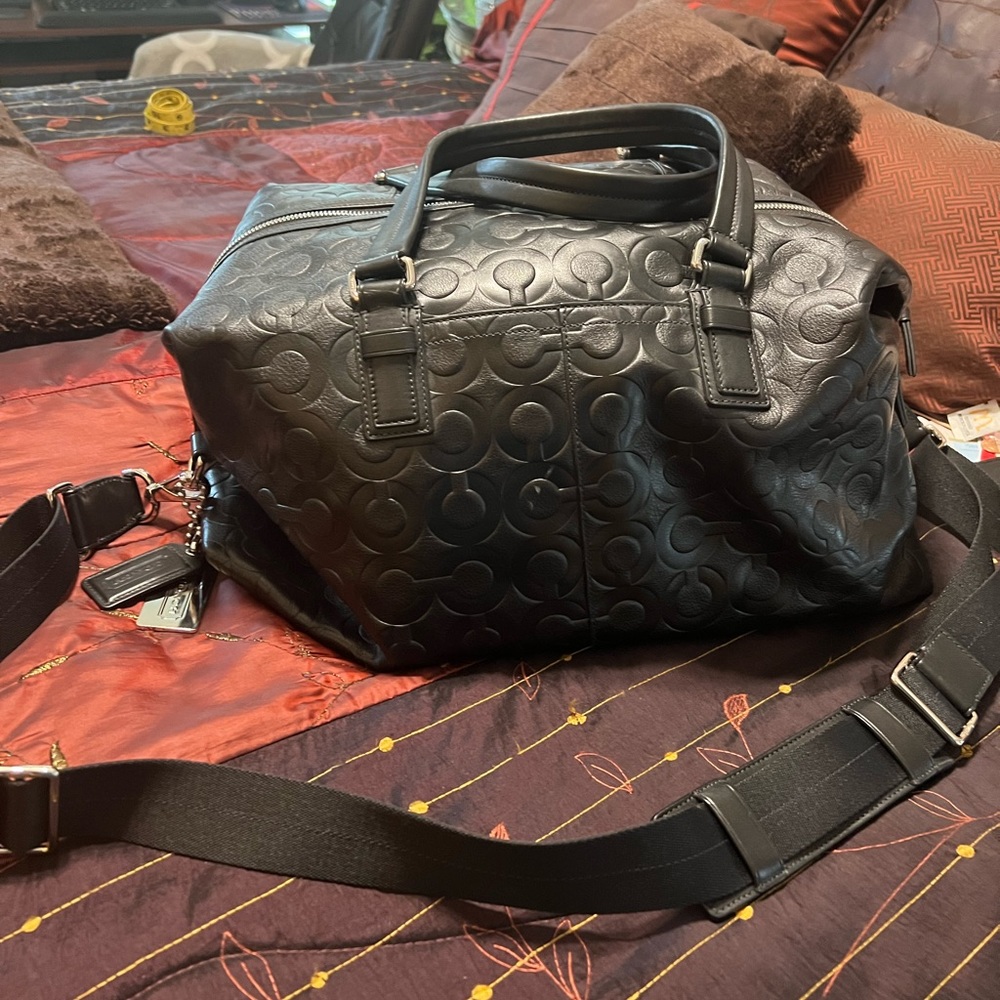 Men’s/women’s Coach embossed leather overnight bag.